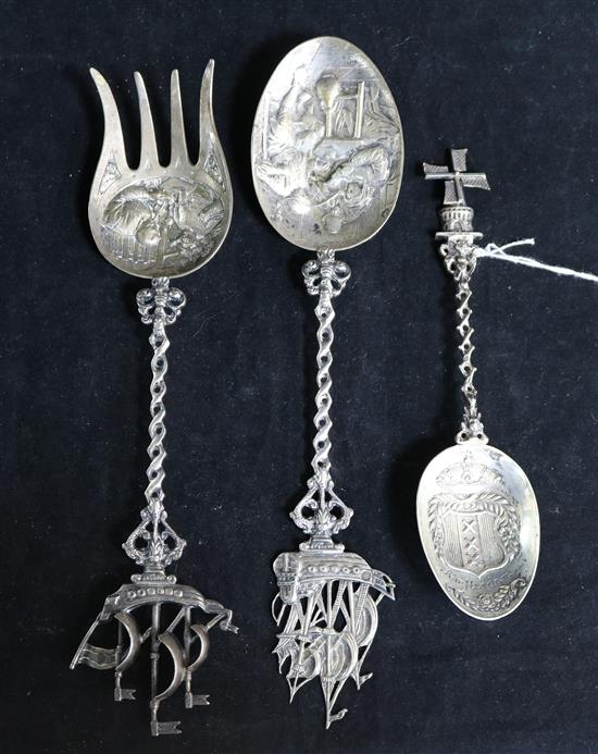 A Dutch embossed silver spoon with tavern scene bowl and galleon finial, a similar fork with Viking ship finial and a souvenir spoon,